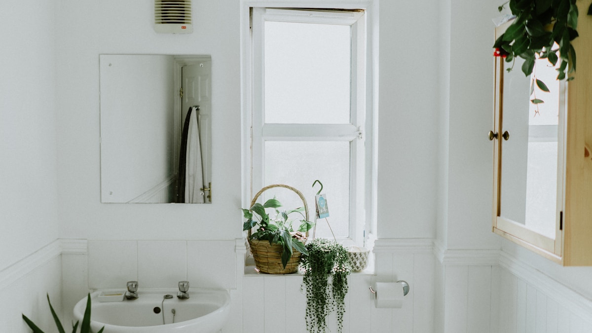 A modern bathroom with a subtle ceiling exhaust fan, emphasizing good ventilation.