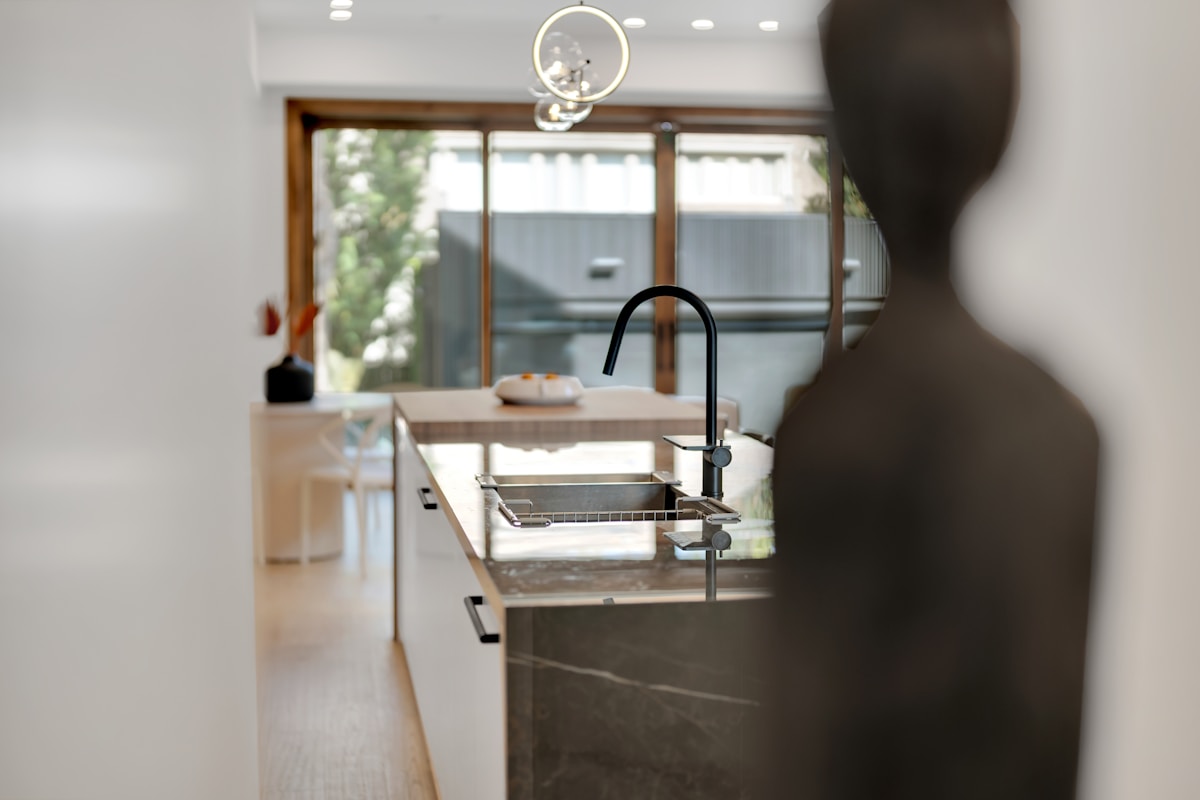 Modern kitchen faucet installation showing chrome finish and pull-down sprayer