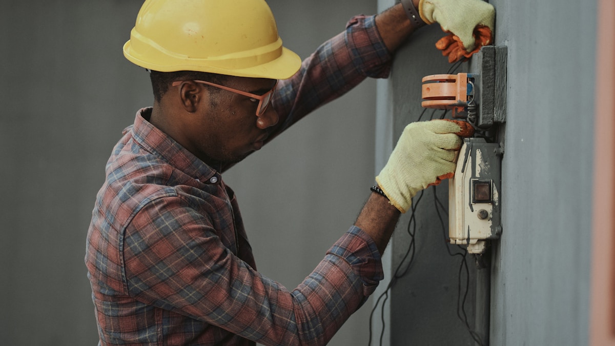 Light switch installation showing hands working with wiring
